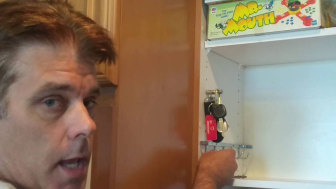 Used a closet doctor sliding belt rack for key storage in a kitchen cabinet.